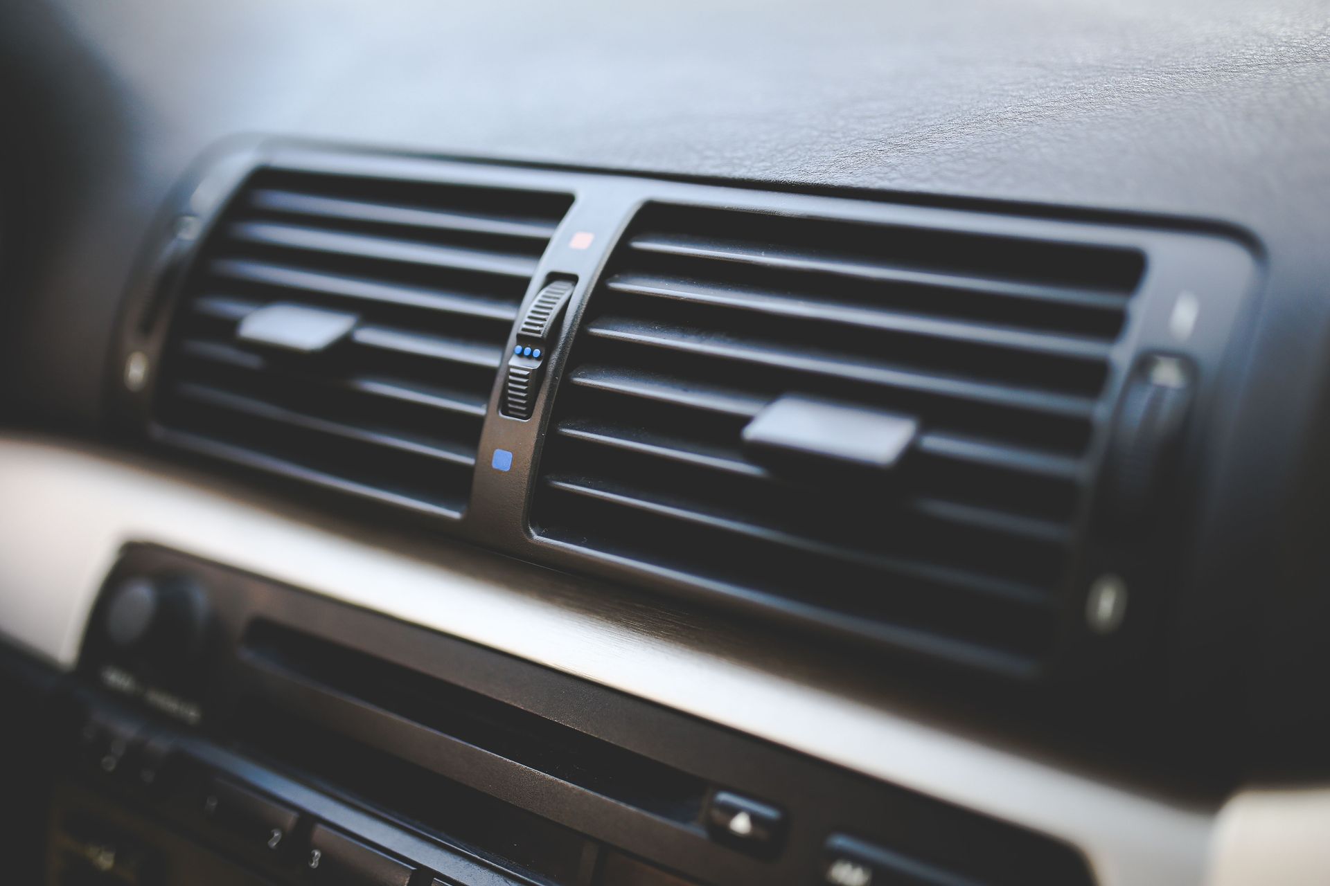 Detailed view of air conditioning vents in the interior of a BMW car, showcasing modern automotive design.